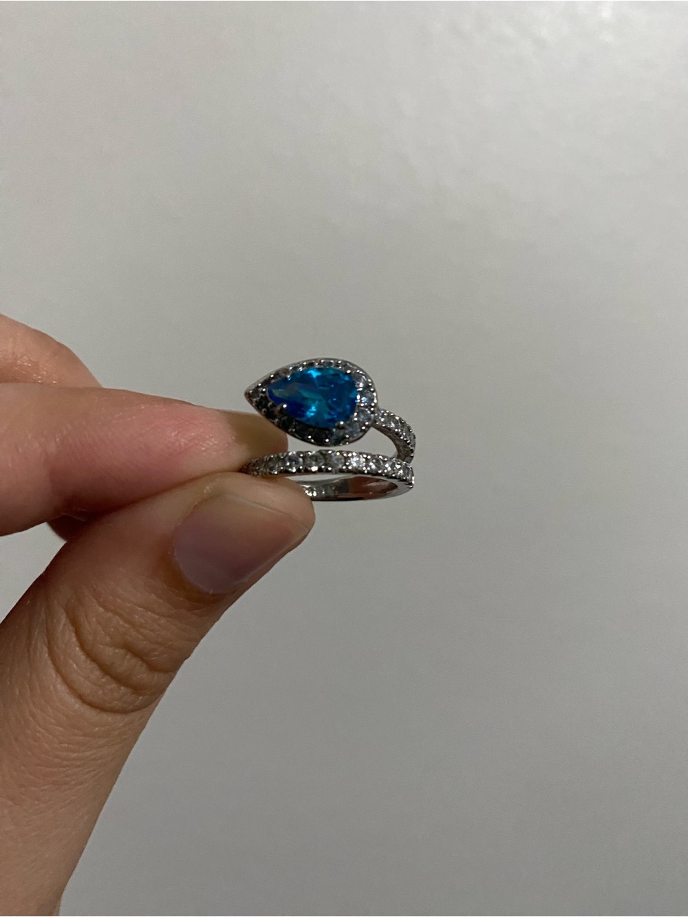 pear cut blue gemstone silver ring with diamond accents